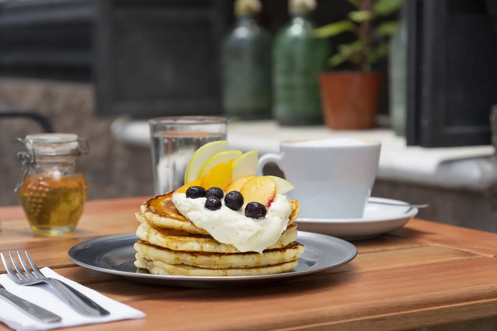 Pancakes and coffee on a cafe table. The photo was not taken at a Milton restaurant.