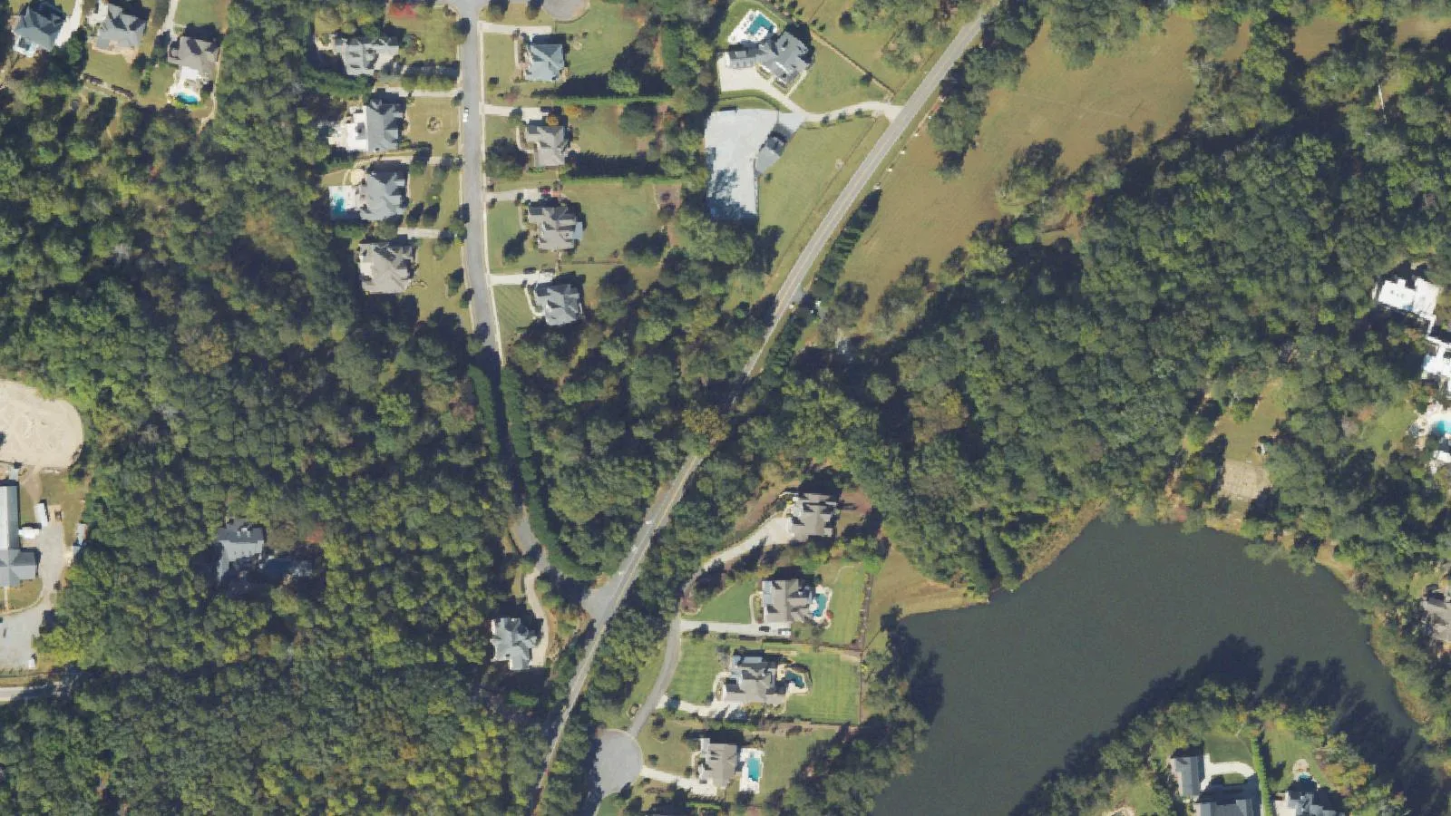 Aerial view of Freemanville Road where it crosses the wooded Cooper Sandy Creek valley south of Providence Road, before the old bridge was torn down.