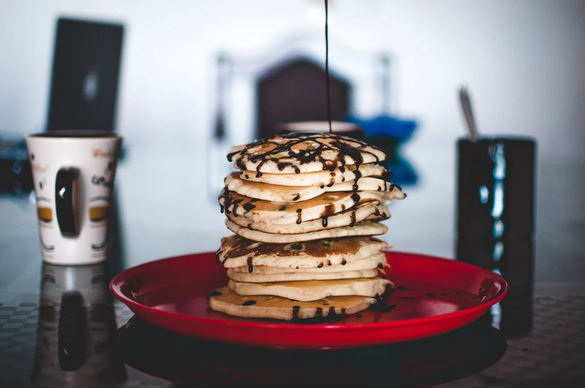 A stack of pancakes with chocolate syrup, not taken at the Milton breakfast
