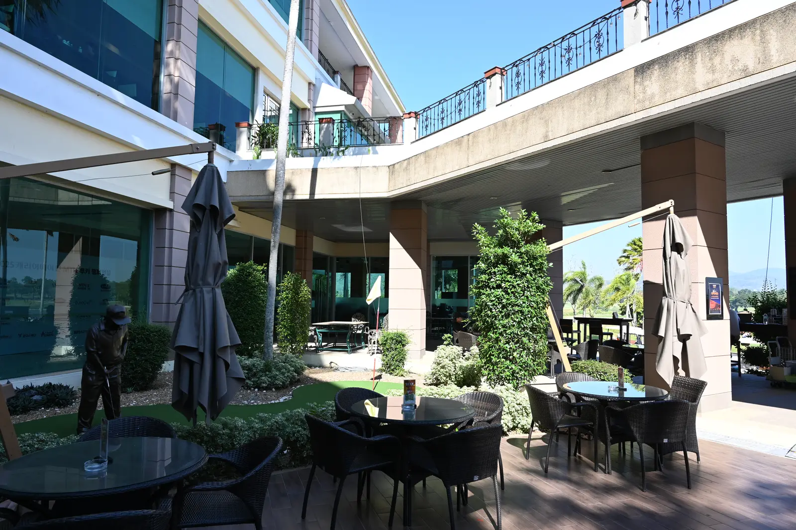 Tables and umbrellas on a cafe patio. The photo was not taken in Milton.