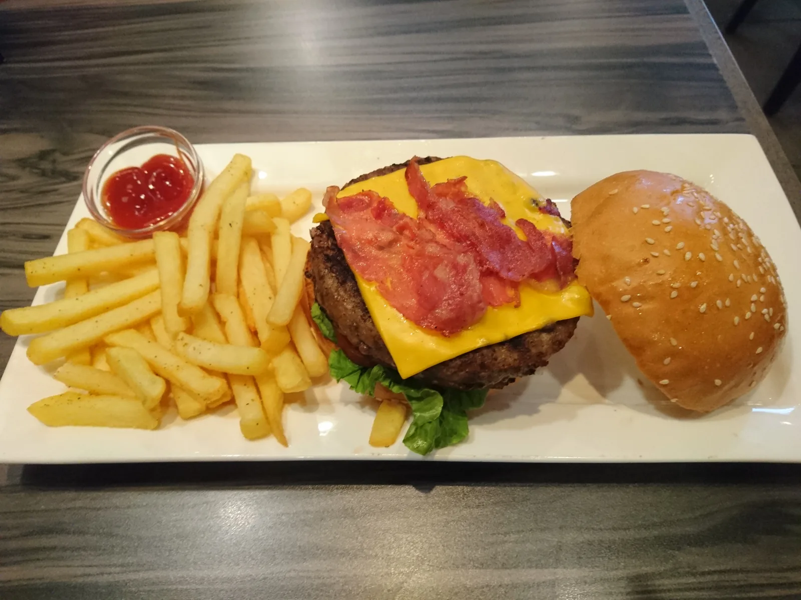A bacon cheeseburger with fries. The photo was not taken at a Milton restaurant.